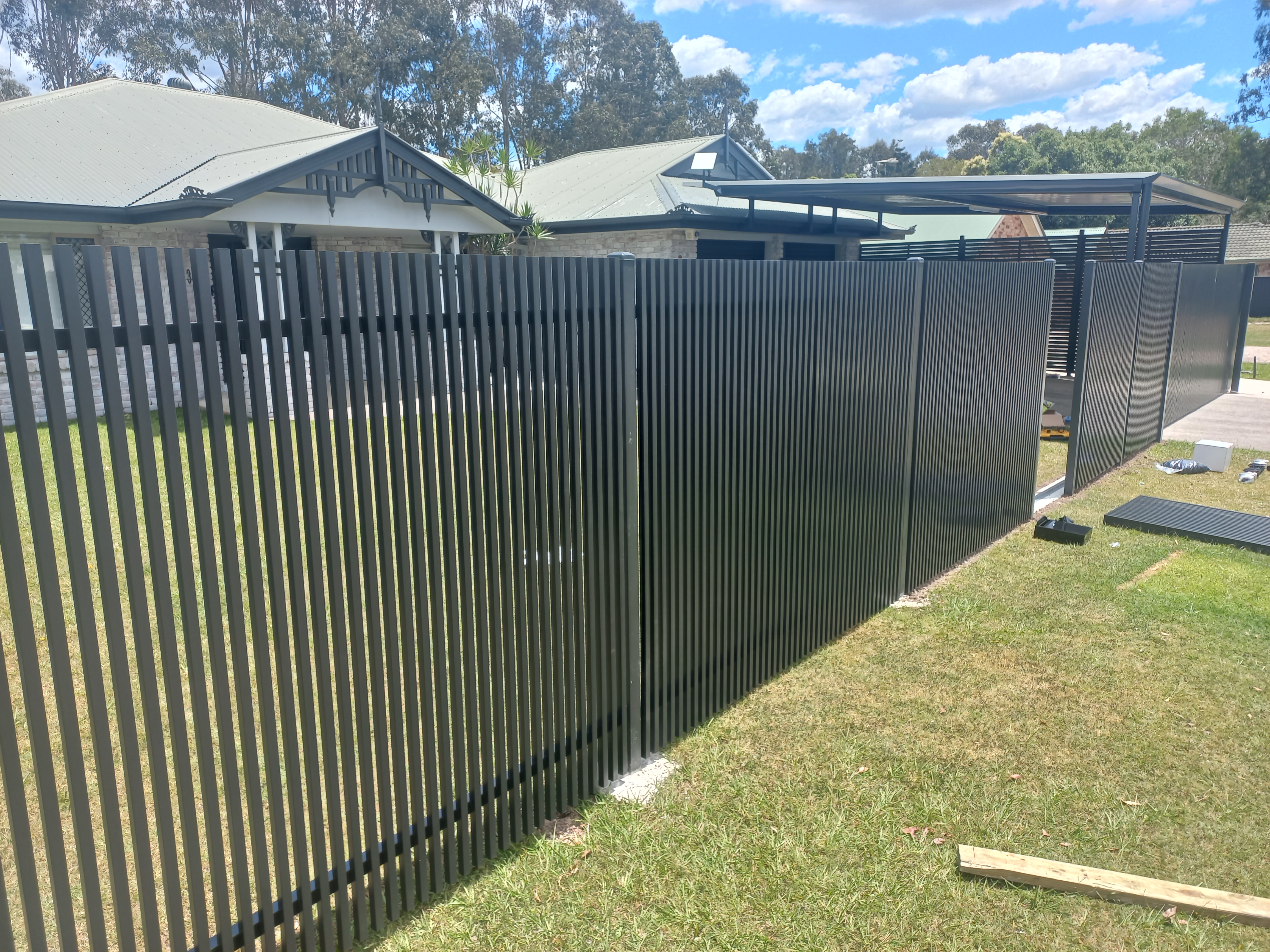 Black tubular pool and driveway fencing fabricated and installed by our crew - Gateflex, Caboolture