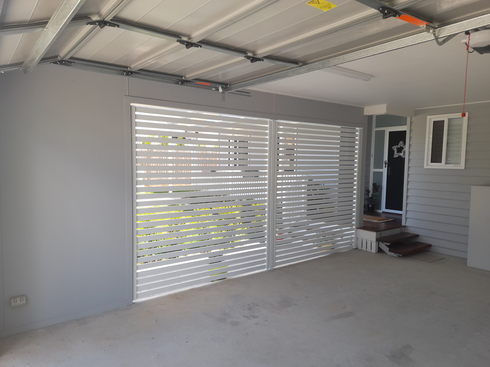 White horizontal slat aluminium louvre privacy screen installed inside a garage entry - Gateflex, Caboolture
