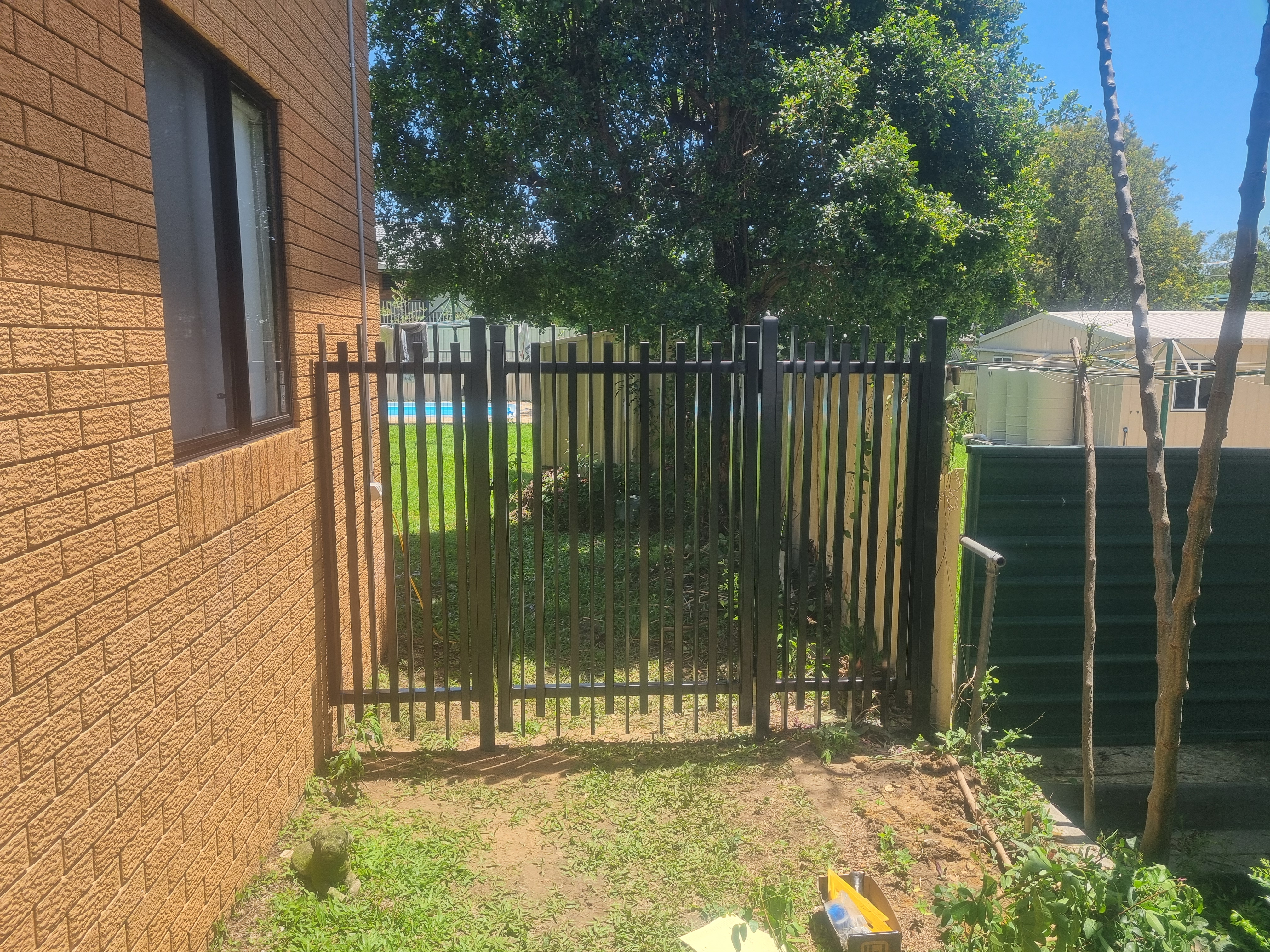 Black tubular front fence installed at a Bribie Island brick home - Gateflex, Bribie Island