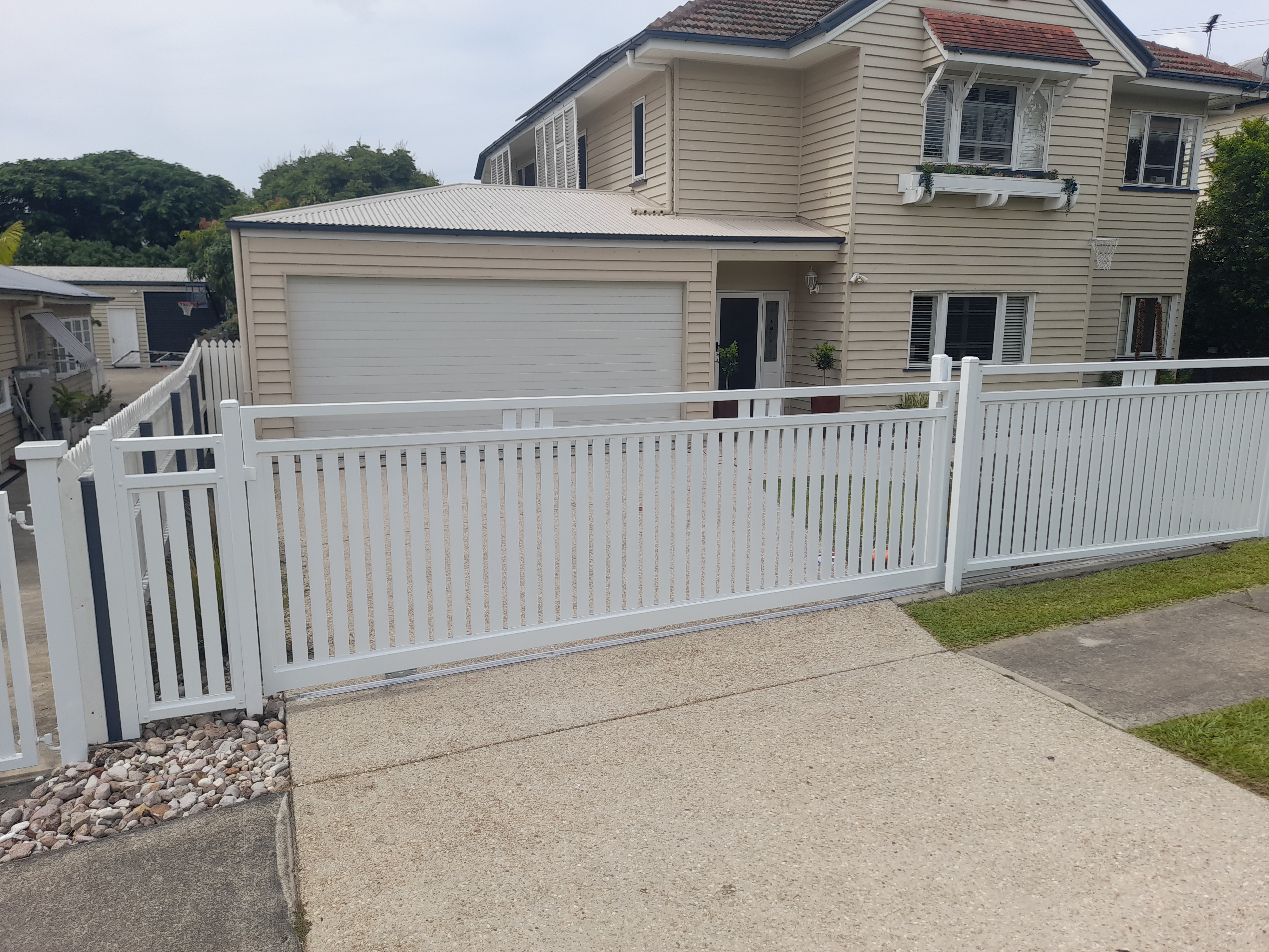 White aluminium double swing gate fitted between picket fence panels - Gateflex, Caboolture