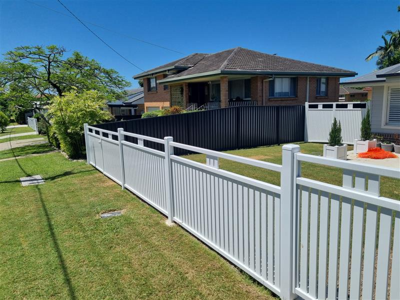 White aluminium picket fence in front yard with dark Colorbond fence behind across a Caboolture street - Gateflex, Caboolture