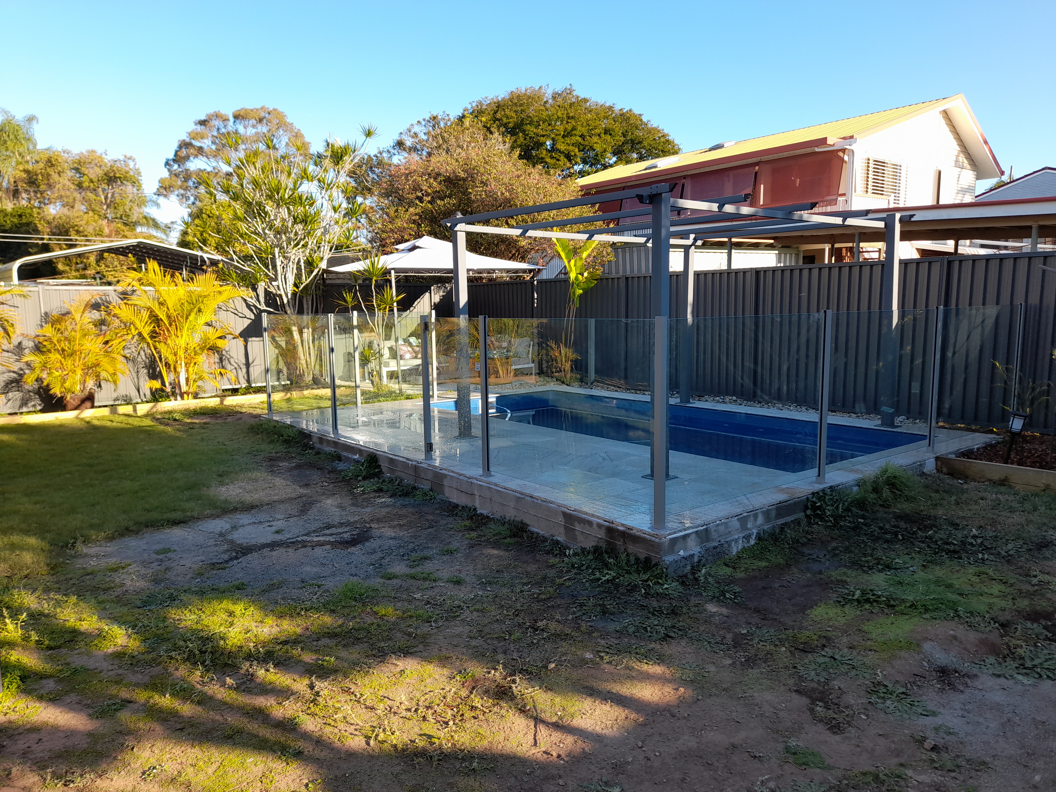 Black louvered aluminium screen enclosing pool equipment in Redcliffe - Gateflex, Redcliffe