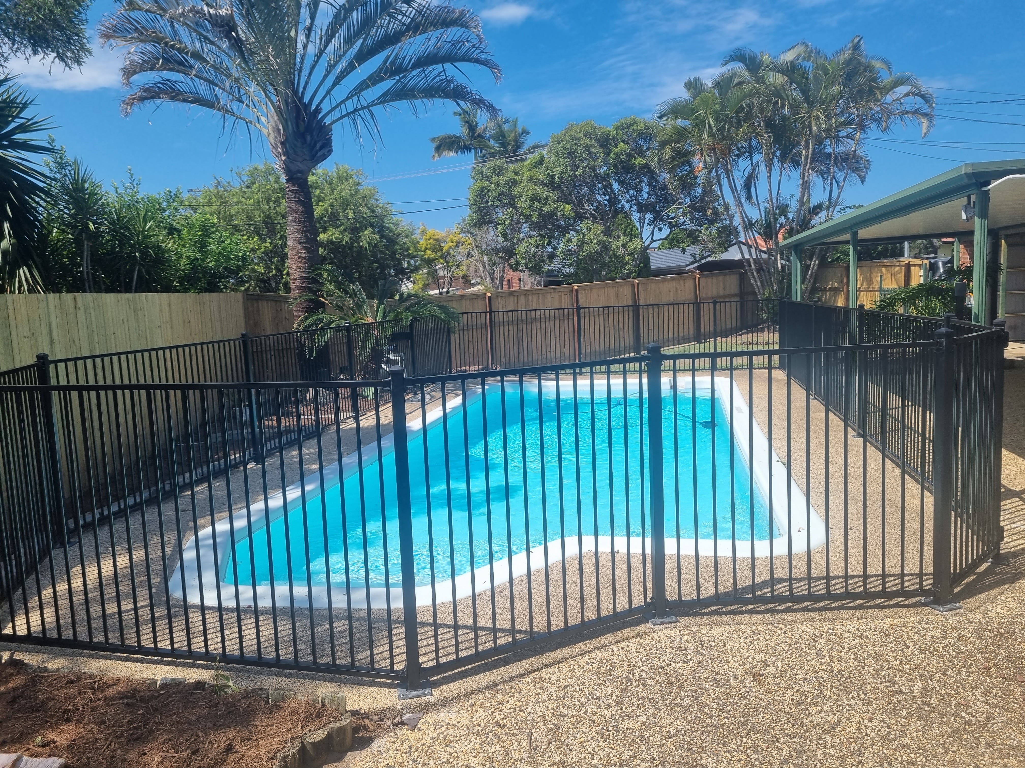 Designer pool surrounded by black tubular pool fencing in Burpengary - Gateflex, Burpengary