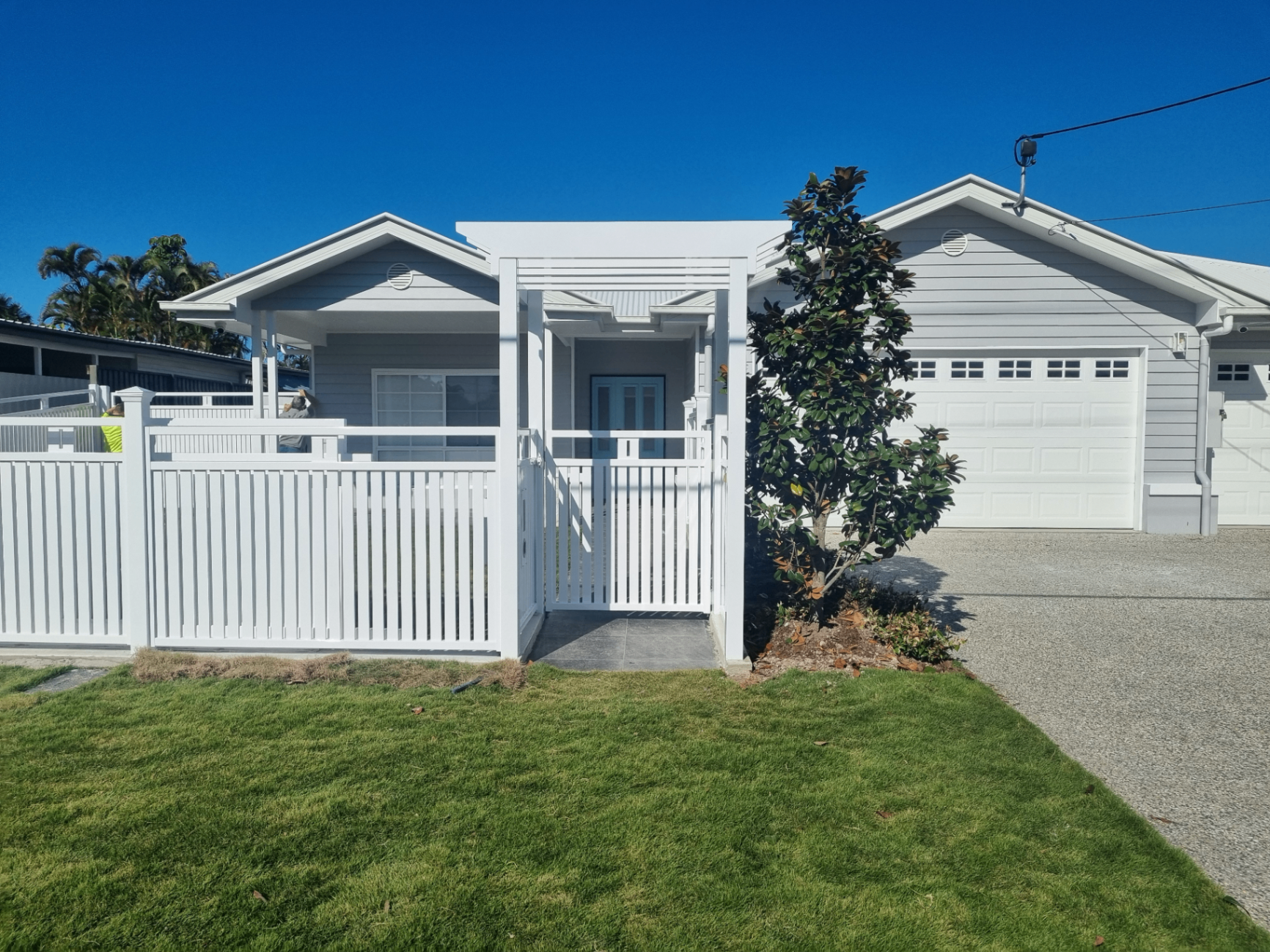 White aluminium picket fence and matching pedestrian gate at the front entry of a Caboolture home - Gateflex, Caboolture